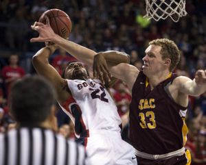Gonzaga’s Byron Wesley (22) is fouled by Sam Berlin (33) of St. Thomas Aquinas during the first half. (Colin Mulvany)