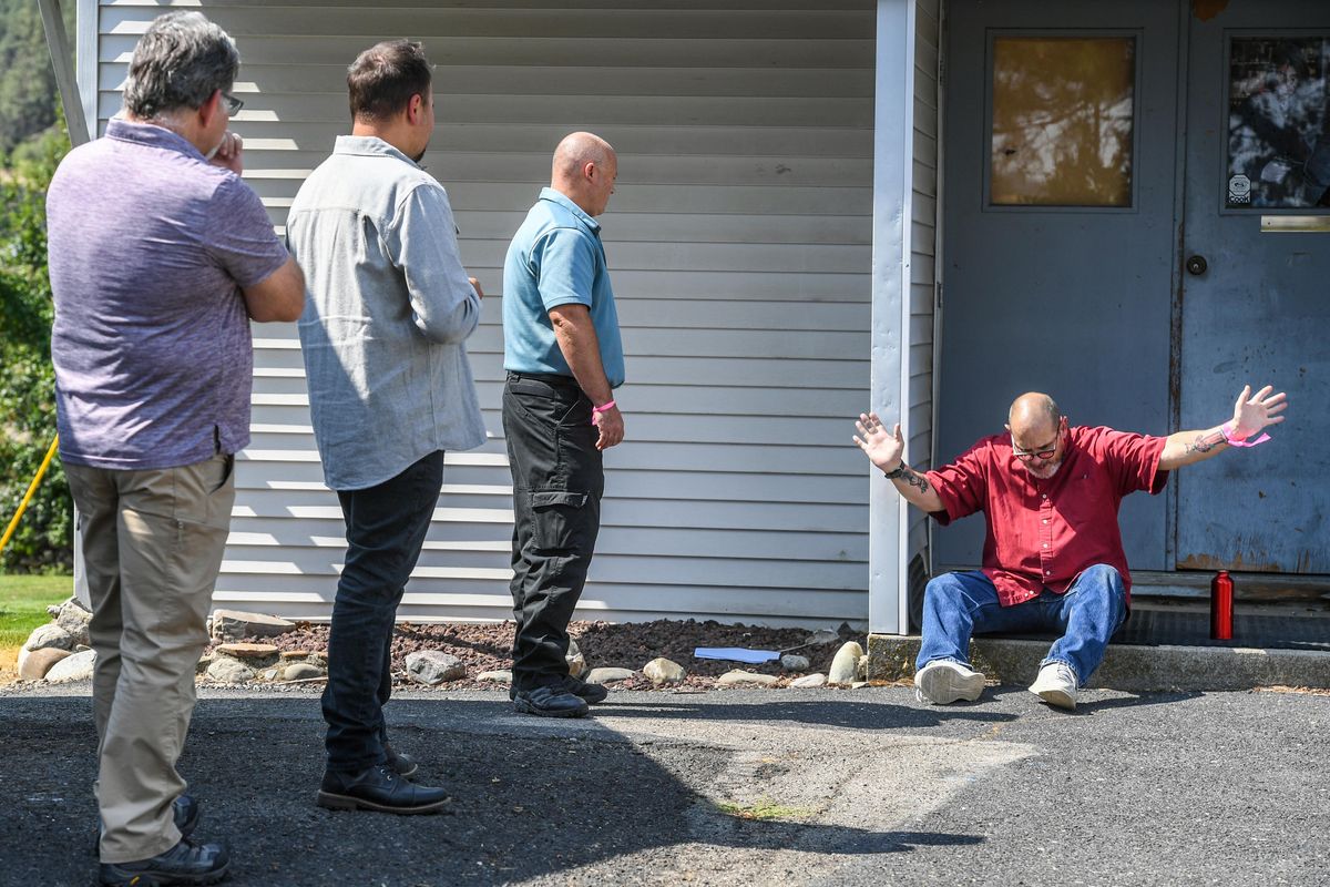 Kelly McGuire, of Frontier Behavioral Health, right, plays the role of a vet in crisis during a crisis intervention training for Spokane County Sheriff’s detectives, from left, Jesse Depriest, Stan Kravtsov and deputy Evan Logan on Wednesday at the Spokane Police Academy.  (Dan Pelle/THE SPOKESMAN-REVIEW)