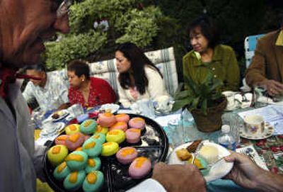 
Attendees sit down for tea and treats at the 2006 party. 
 (File / The Spokesman-Review)