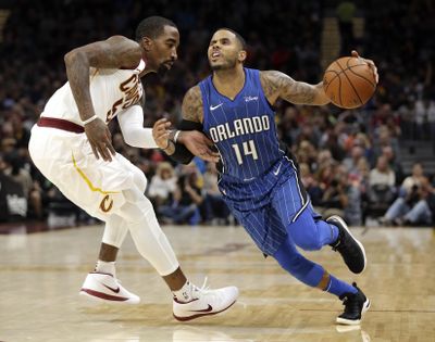Orlando’s D.J. Augustin drives past Cleveland’s JR Smith in the second half of Saturday’s game. (Tony Dejak / Associated Press)