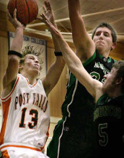 
Post Falls senior K.C. Billetz, left, gets a shot over the reach of Jacob Harris, center, and Matt Luedeman of Blackfoot during the second half. 
 (Matt Cilley/Special to / The Spokesman-Review)