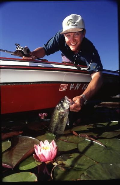 Spokane's Bobby Forster lands a bass while fishing at Lake Coeur d'Alene. (Rich Landers)