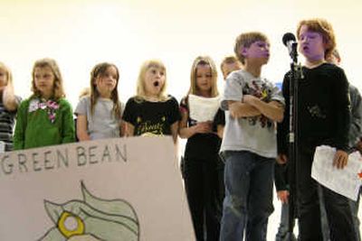 
Spirit Lake second-graders Eric Murphy and Darla Parks, at the microphone, performed the Earth Day Poem 
