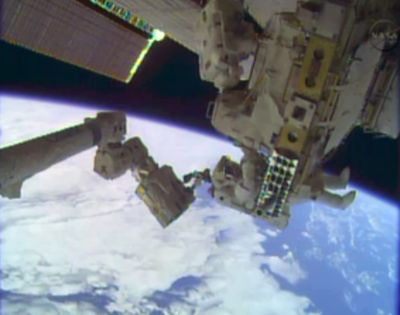 In this image taken from video provided by NASA, astronauts Rick Mastracchio, top, and Michael Hopkins work outside the International Space Station on Tuesday. (Associated Press)