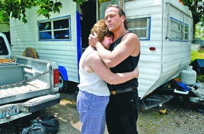 
Cecile Jones, left, hugs Billy Ashton last Friday where Trent Yohe was restrained and Tasered during an arrest by Spokane County sheriff's deputies and Spokane Valley police. Jones says officers kicked Yohe while he was restrained; Ashton fled when deputies arrived.
 (Holly Pickett / The Spokesman-Review)