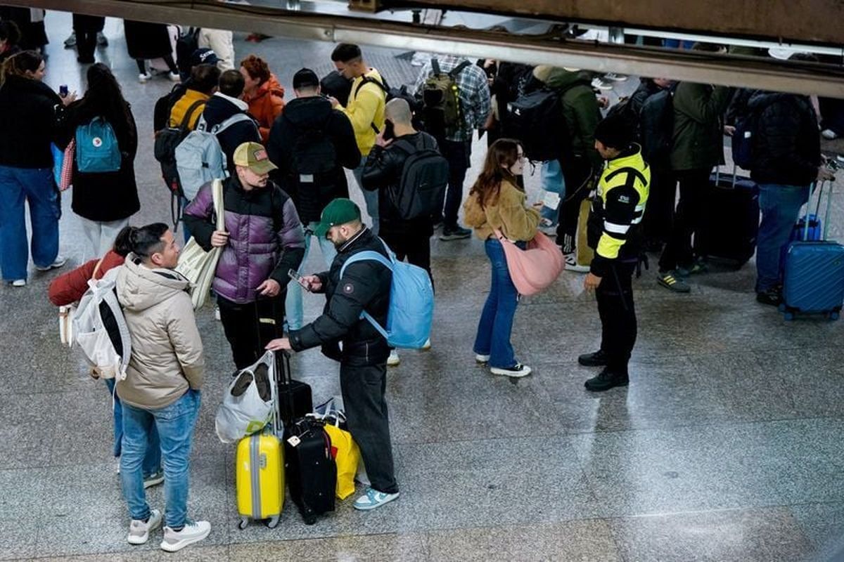 Passengers gather at the Atocha train station, amid train delays and cancellations, following a deadly derailment of two high-speed trains in Adamuz near, Cordoba, according to local police reports on Sunday in Madrid.  (Reuters )