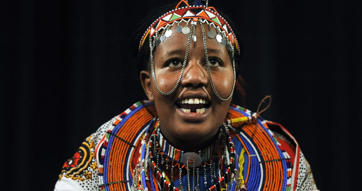 Joyce Seita Pulei, 24, a member of  the Maasai dance troupe Osotua Le Keekonyokie, performs Saturday at the Fall Folk Festival at Spokane Community College.  (Dan Pelle)