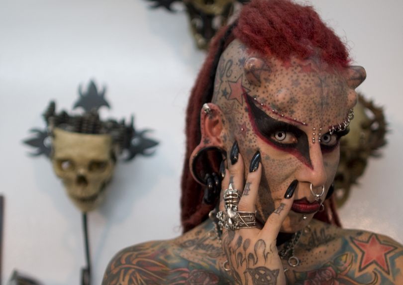 Maria Jose Cristerna poses for pictures during a press conference at a tattoo shop in Bogota, Colombia, Friday, June 3, 2011. The Mexican tattoo artist said she started to cover her body in tattoos, piercings, titanium implants and dental fangs to re-invent herself as a vampire, her reaction after suffering domestic violence. Cristerna is in Colombia to attend a tattooing international convention. (William Martinez / Associated Press)