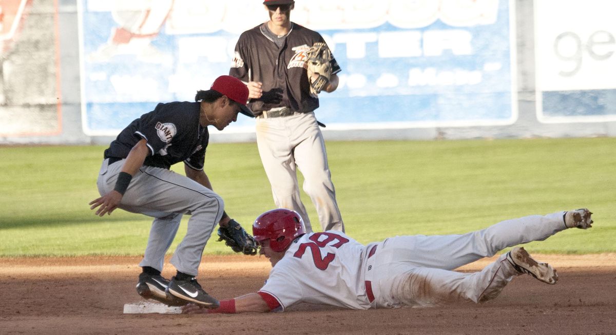 Spokane Indians’ Kellen Strahm, right, steals second base as Salem-Keizer’s Marcos Campos is late to apply the tag in the second inning on Wednesday, July, 3, 2019, at Avista Stadium in Spokane. (Kathy Plonka / The Spokesman-Review)