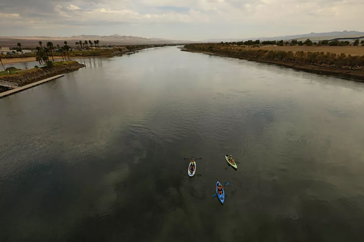 Kayakers float down the Colorado River through Fort Mojave. Fort Mojave Indian Reservation owns land along the Colorado River, which is essential to their heritage and survival.    (Carolyn Cole/Los Angeles Times/TNS)