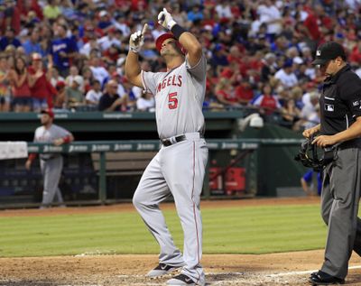 Angels’ Albert Pujols points to sky after second HR. (Associated Press)