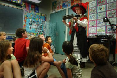 
Lou Carver uses period clothing and artifacts during a historical presentation to Moran Prairie Elementary third-grade students last week. Carver often gives presentations to schools and area organizations. 
 (Brian Plonka photos/ / The Spokesman-Review)