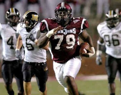 
Troy State offensive lineman Junior Louissaint launches his 277-pound frame toward the end zone after a fumble recovery. 
 (Associated Press / The Spokesman-Review)