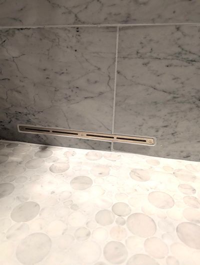 This narrow slot is connected to a high-speed fan that blows air into a shower. The air removes the water, stopping the growth of mold and mildew.  (Tribune Content Agency)