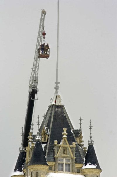 
A crew works to remove the flagpole atop the Spokane County Courthouse on Friday. A windstorm left the pole leaning.
 (Christopher Anderson / The Spokesman-Review)