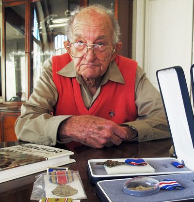 Tom Harrison, 93, displays his World War II medals at his home in Salt Lake City. (Associated Press)