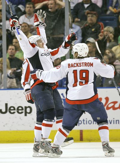 Washington’s Mike Green and Nicklas Backstrom celebrate a record.  (Associated Press / The Spokesman-Review)