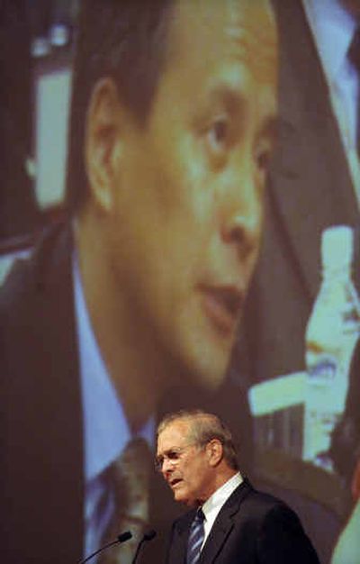 
U.S. Defense Secretary Donald H. Rumsfeld, front, listens to a question by Cui Tiankai, China's highest ranking delegate to a meeting of Asian defense ministers today in Singapore. 
 (Associated Press / The Spokesman-Review)