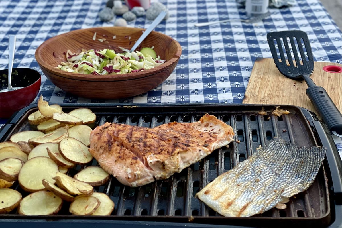 Coho is grilled outdoors along with potatoes for a fall RVing feast. (Leslie Kelly)