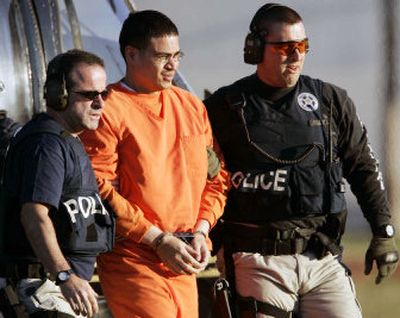 
Jose Padilla, center, an alleged al-Qaida operative held for nearly four years as an enemy combatant, is escorted by federal marshals in Miami on Thursday. 
 (Associated Press / The Spokesman-Review)