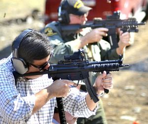 Idaho Congressman Raul Labrador aims a gun after the official handoff of land near Riggins, Idaho, for a new shooting range Wednesday. (Barry Kough/Lewiston Tribune via AP)