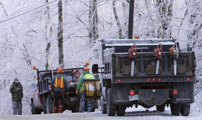 Workers  gather Saturday  to clear roads in Washington, N.H. It was the third night without electricity for many in the region.  (Associated Press / The Spokesman-Review)