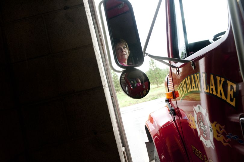 Toni Halloran, Deputy Chief of Newman Lake Fire and Rescue, concentrates as she maneuvers a water tender into the cramped confines of Station 1 on Tuesday. Newman Lake Fire and Rescue is again preparing to ask voters to pass a bond to replace Station 1. (Tyler Tjomsland)