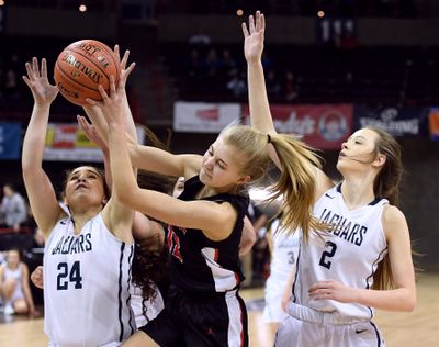 St. George’s forward Hadlie Kaiser  grabs a rebound away from Tri-Cities Prep guard Alyssa Monteon (24) and forward Makenna Brandner (2) during Wednesday’s State 2B play at  the Spokane Arena. (Colin Mulvany / The Spokesman-Review)