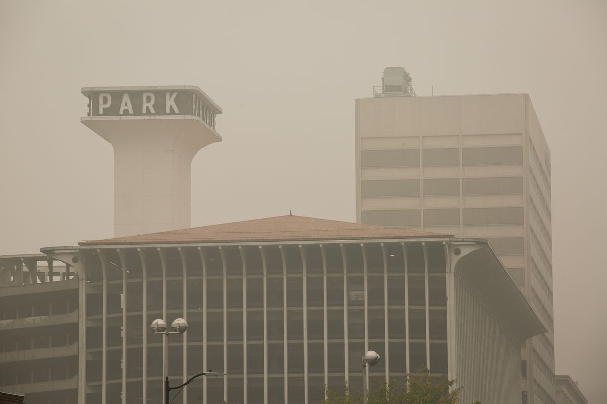 The Parkade and other buildings in downtown Spokane are seen through a haze of wildfire smoke on Sunday, Sept. 13, 2020, as the air quality nearly reached the upper limit of the "hazardous" category on the federal air quality index. Experts say wildfires along the West Coast are becoming more dangerous and less predictable as climate change creates hotter, drier conditions.  (Libby Kamrowski / The Spokesman-Review)