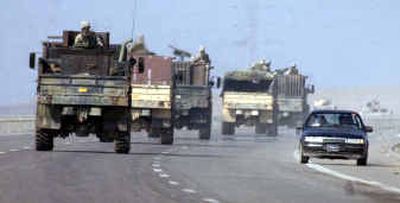 
American soldiers convoy toward the insurgent-held city of Fallujah, as Fallujah residents evacuate Friday. 
 (Associated Press / The Spokesman-Review)