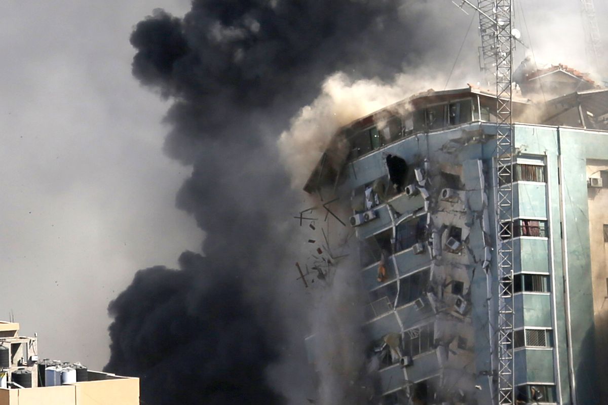 The building housing the offices of The Associated Press and other media in Gaza City collapses after it was hit by an Israeli airstrike Saturday, May 15, 2021. The attack came roughly an hour after the Israeli military warned people to evacuate the building, which also housed Al-Jazeera and a number of offices and apartments. There was no immediate explanation for why the building was targeted.  (Hatem Moussa)