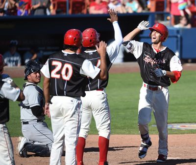 Spokane’s Josh Merrigan, right, is greeted by teammates after his seventh-inning three-run home run gave the Indians a 4-1 lead over the Everett Aquasox on Sunday at Avista Stadium. Spokane won 6-4. (JESSE TINSLEY jesset@spokesman.com)