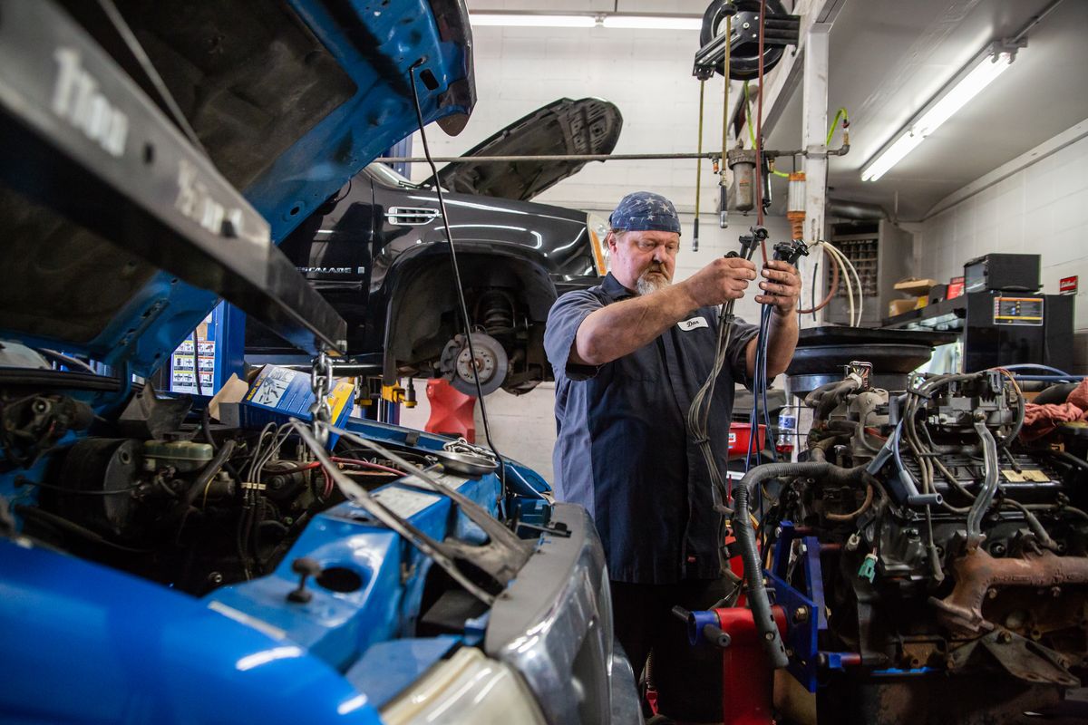 Auto technician Dan Lane of Save More Automotive on N. Hamilton St. works to rebuild the silverheads on a blown head gasket belonging to a Ford pickup truck on Monday, Aug. 16, 2021. Lane