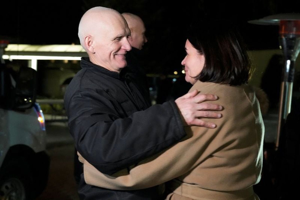 Belarusian opposition leader Sviatlana Tsikhanouskaya welcomes Ales Bialatski, prisoner released from Belarus, as he arrives at the U.S. embassy in Vilnius, Lithuania Saturday. (Ints Kalnins/Reuters )
