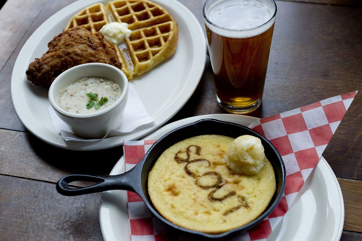 Chicken and waffles are pictured with a corn bread skillet at Scout. (Tyler Tjomsland)