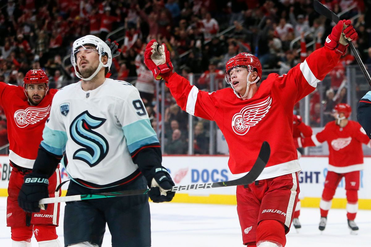 Detroit Red Wings right wing Lucas Raymond (23) celebrates his goal as Seattle Kraken center Marcus Johansson (90) reacts during the third period of an NHL hockey game Wednesday, Dec. 1, 2021, in Detroit. The Red Wings defeated the Kraken 4-3 in a shootout.  (Duane Burleson)