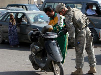 
A U.S. soldier inspects a scooter in Baghdad on Tuesday. U.S. and Iraqi forces  continued searches Tuesday for a missing U.S. soldier who may have been kidnapped.
 (Associated Press / The Spokesman-Review)
