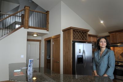 Realtor Melissa Dailey stands in a new $450,000 home built by Lexington Homes, which she represents, Thursday.  Local banks that helped finance these houses are offering 3.875 percent interest mortgages to help entice buyers, thus sharing the burden of the slow market with the homes’ builder.  (Jesse Tinsley / The Spokesman-Review)