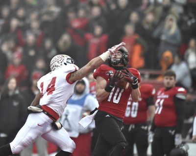 Eastern Washington receiver Cooper Kupp (10) hauls in a long pass to put EWU in scoring position against Illinois State's DraShane Glass (14) during the first half of an FCS quarterfinal football game on Saturday, Dec 13, 2014, at Roos Field in Cheney, Wash. (Tyler Tjomsland / The Spokesman-Review)