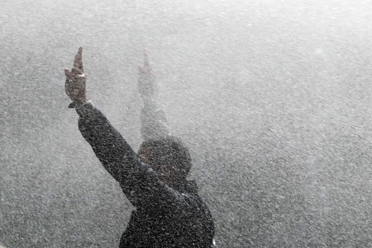 An Egyptian protester flashes the V-sign as riot police use water canon against protesters in Cairo, Egypt, Friday, Jan. 28, 2011. Egyptian anti-government activists clashed with police for a second day Wednesday in defiance of an official ban on any protests but beefed up police forces on the streets quickly moved in and used tear gas and beatings to disperse demonstrations. (Lefteris Pitarakis / Associated Press)