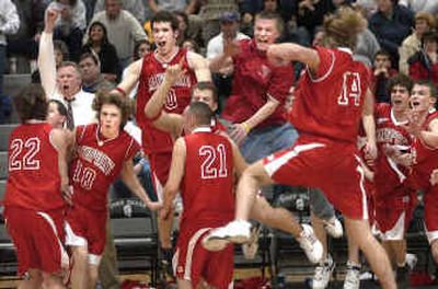 
The Sandpoint Bulldogs react after their 71-63 overtime win over Post Falls sent them to the state tournament for the first time in nearly three decades. 
 (Tom Davenport/ / The Spokesman-Review)