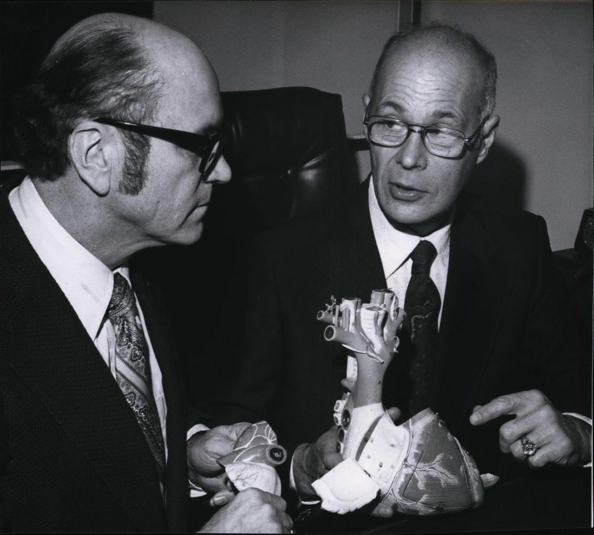 Spokane heart surgeon Dr. Ralph Berg Jr. (right) explains surgical procedures to Neighbors of Woodcraft state director Don E. Belangie in this photo dated 1976.