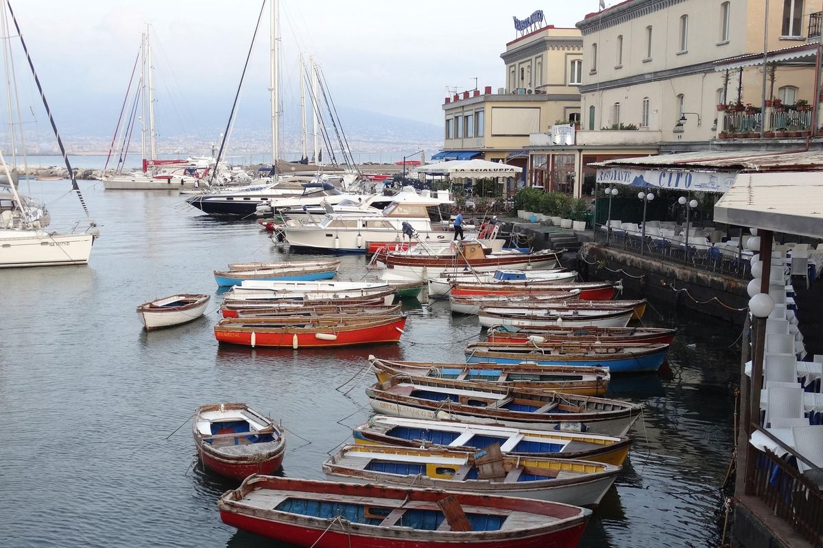 At left: Naples’ waterfront isn’t always easy to reach, but it remains a busy and picturesque harbor. (David Hage / TNS)