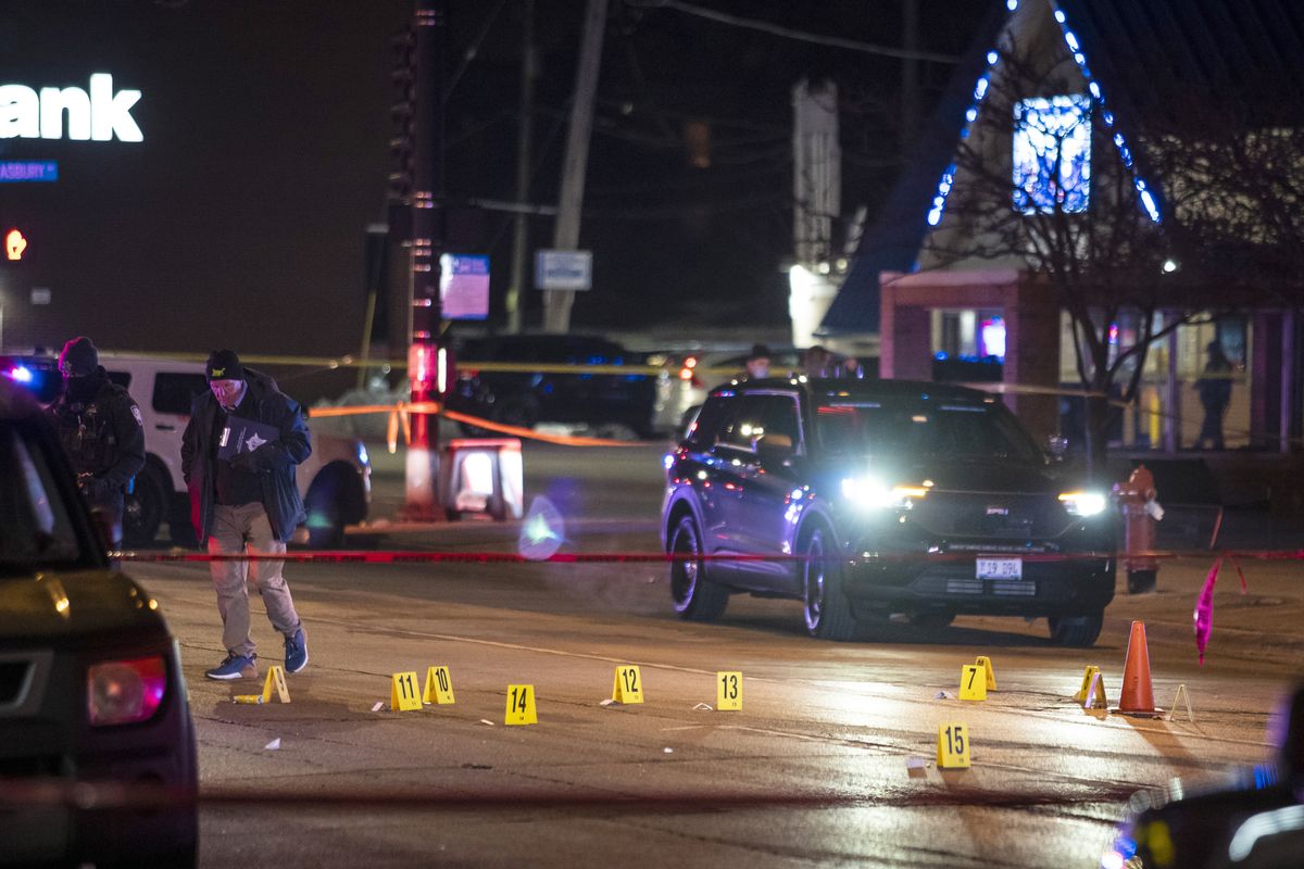 Chicago and Evanston police investigate a crime scene after a gunman went on a shooting spree before being killed by police during a shootout in Evanston, Ill., Saturday night, Jan. 9, 2021.  (Ashlee Rezin Garcia)