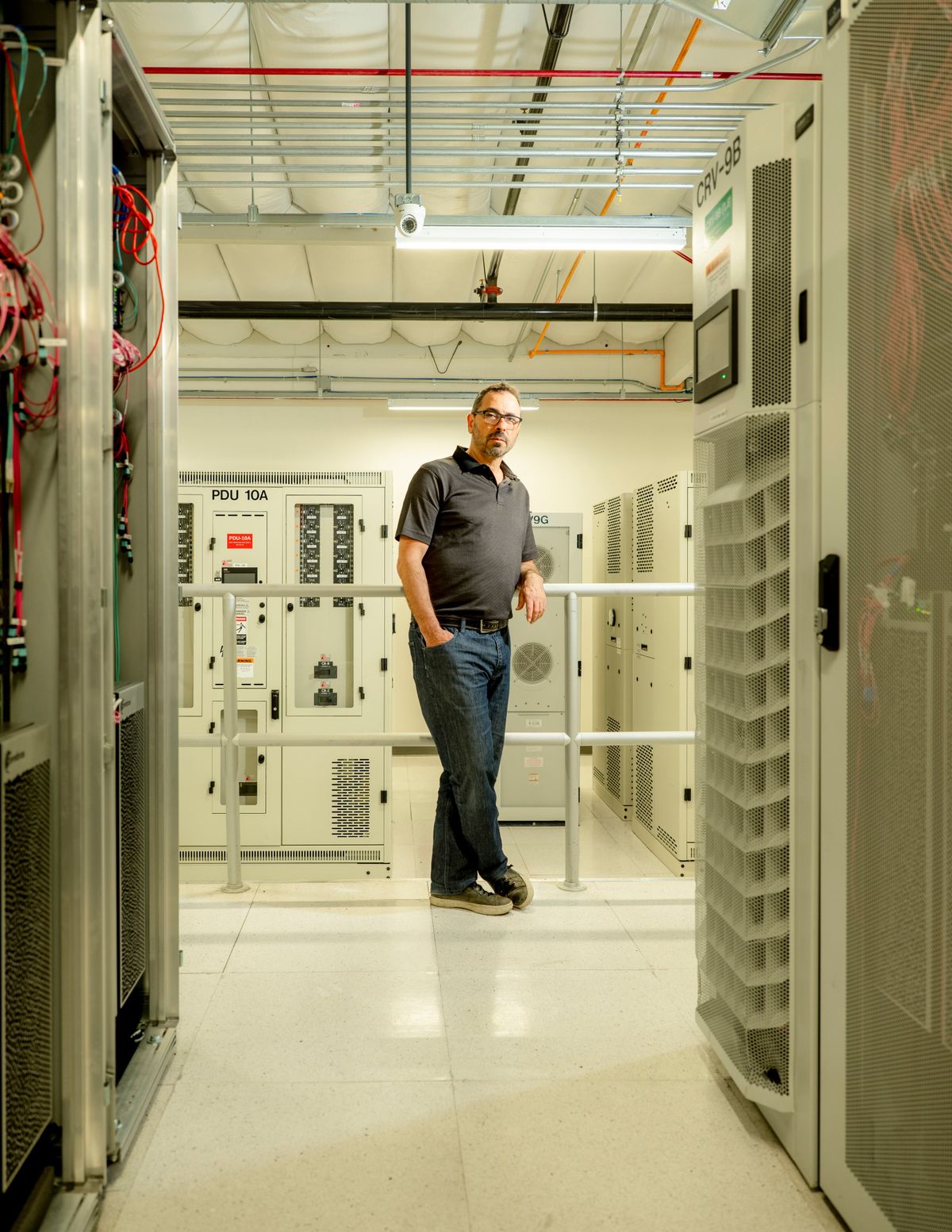 Andrew Feldman, chief executive of Cerebras, stands with a new AI supercomputer at a data center in Santa Clara, Calif., earlier this week. The new supercomputer was unveiled as the AI boom drives demand for chips and computing power.  (New York Times)