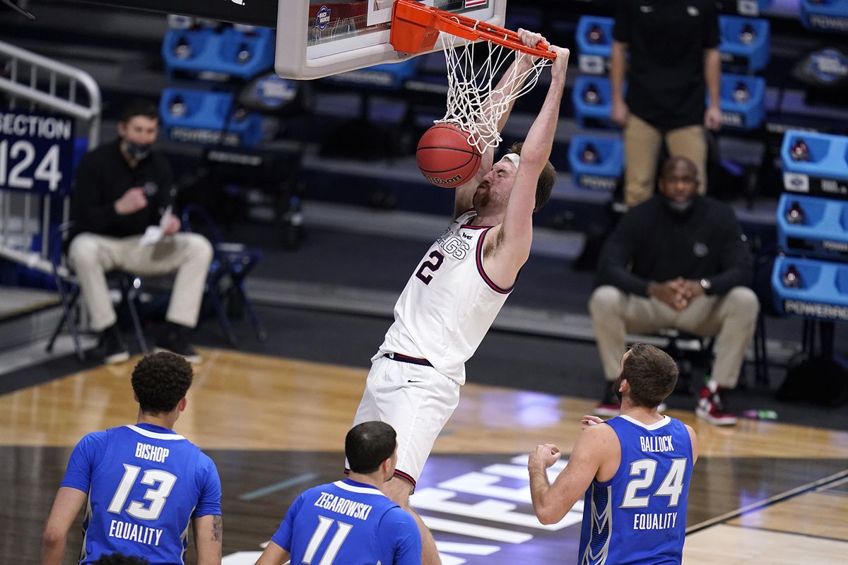 Gonzaga forward Drew Timme (2) dunks as Christian Bishop (13), Marcus Zegarowski (11) and Creighton guard Mitch Ballock (24) look on in the second half of a Sweet 16 game in the NCAA men