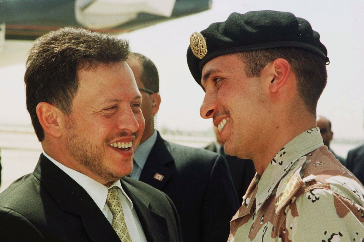 FILE - In this April 2, 2001, file photo, Jordan’s King Abdullah II laughs with his half brother Prince Hamzah, right, shortly before the monarch embarked on a tour of the United States. Abdullah and Hamzah are both sons of the beloved King Hussein, who ruled Jordan for nearly a half-century before his death in 1999. Abdullah had appointed Hamzah as crown prince upon his succession but stripped him of the title in 2004.  (YOUSEF ALLAN)