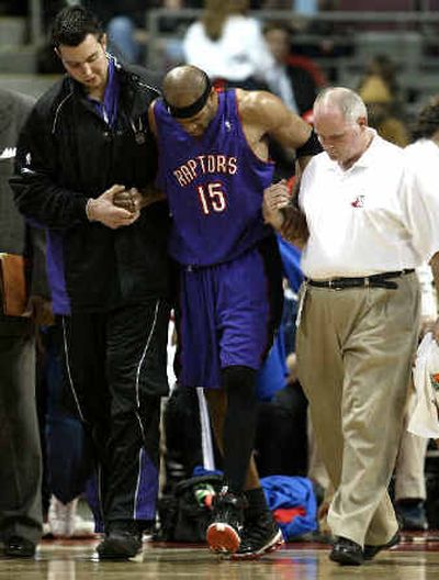 
Toronto's Vince Carter (15) left early in the second half with an Achilles' tendon injury.
 (Associated Press / The Spokesman-Review)