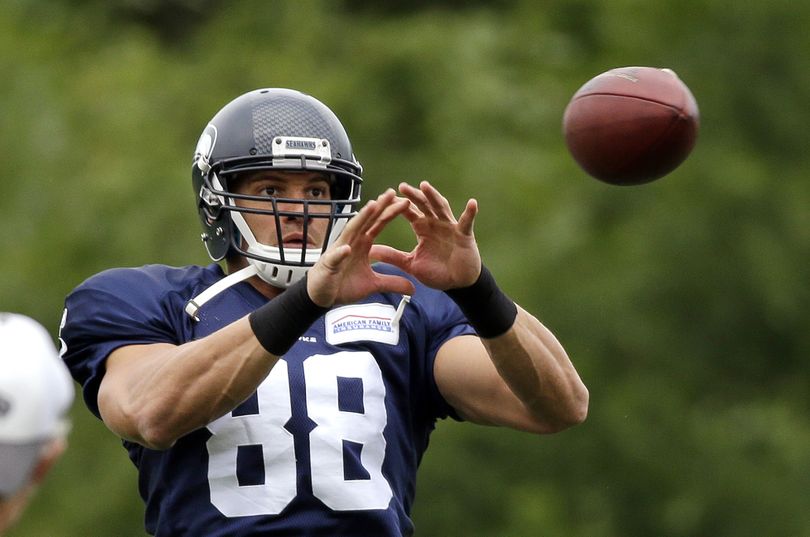 Newcomer Jimmy Graham reaches to catch a ball at the Seattle Seahawks camp on Monday. (Associated Press)