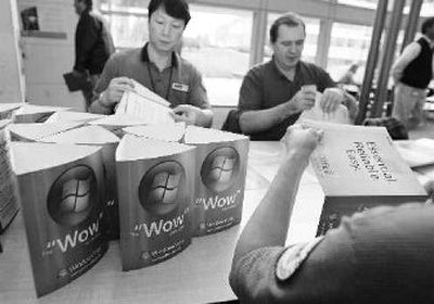 
Microsoft Corp. custodial workers Ching Lee, left, and Nikolay Yurchuk prepare signs promoting the upcoming release of the Windows Vista computer operating system on Thursday. 
 (Associated Press / The Spokesman-Review)